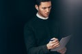 Portrait of pensive young handsome man have a conversation with colleagues during meeting with wireless earphones. Royalty Free Stock Photo