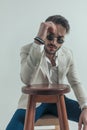 Pensive young man with elbow on wooden chair thinking Royalty Free Stock Photo