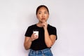 Portrait of pensive young woman holding takeaway coffee Royalty Free Stock Photo