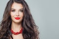 Portrait of perfect brunette woman with red lips makeup and long curly hair