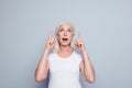 Portrait of perfect, nice, old, impressed woman in t-shirt demon