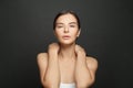 Portrait of perfect nice woman with clean shiny fresh skin against black studio wall background