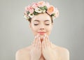 Portrait of perfect woman spa model with clear skin, manicured nails and flowers