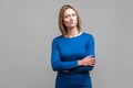 Portrait of perplexed thoughtful woman looking aside with doubting inquiring expression. indoor studio shot isolated on gray