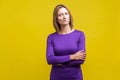 Portrait of perplexed thoughtful woman looking aside with doubting inquiring expression. indoor studio shot isolated on yellow