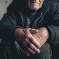 A portrait of a person who is suffering from gout. Closeup of a hands of an elderly person.