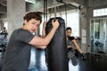 trainer with woman practice boxing in gym