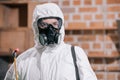 portrait of pest control worker standing in respirator and holding sprayer Royalty Free Stock Photo