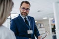 Pharmaceutical sales representative talking with doctor in medical building. Ambitious male sales representative Royalty Free Stock Photo