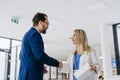 Pharmaceutical sales representative talking with doctor in medical building. Ambitious male sales representative Royalty Free Stock Photo