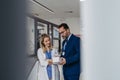 Pharmaceutical sales representative talking with doctor in medical building. Ambitious male sales representative Royalty Free Stock Photo