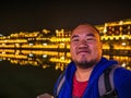 Portrait Photo of Asian fat backpacker with beautiful Scenery view in the night of fenghuang old town