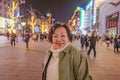 Portrait photo asian women traveler Smile and standing on wangfujing the famous walking Street in beijing