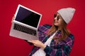 Portrait Photo of beautiful laughing funny smiling blond young woman holding computer laptop with empty monitor screen