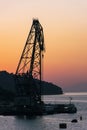 Silhouette of giant crane on Croatian Island at sunset with orange sky Royalty Free Stock Photo