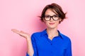 Portrait photo cadre of lady wear formal blue shirt uniform nice glasses hold palm demonstrate new product name 