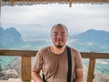 Portrait photo of Fat tourist with beautiful view on the peak of Pha Ngeun in vangvieng City Laos