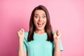 Portrait photo of happy surprised young woman gesturing like winner staring with opened mouth isolated on pastel pink Royalty Free Stock Photo