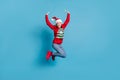 Portrait photo of jumping high happy laughing smiling girl keeping hands over head wearing funny red clothes jeans and