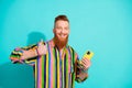 Portrait photo of optimistic red hair beard mustache man has a nice experience rate for new smartphone isolated on cyan Royalty Free Stock Photo