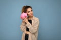 Portrait photo of sincere cute young beautiful attractive woman with dark curly hair in a ponytail wearing casual beige