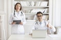 Portrait photo of two young smiling doctors in white medical gown in the clinic office Royalty Free Stock Photo