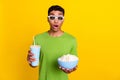 Portrait photo of young attractive funny grimace man shock unexpected moment movie excited hold popcorn soda lemonade