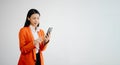 Portrait photo of young beautiful Asian woman feeling happy and holding smart phone, tablet and laptop with black empty screen on Royalty Free Stock Photo