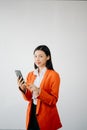 Portrait photo of young beautiful Asian woman feeling happy and holding smart phone, tablet and laptop with black empty screen on Royalty Free Stock Photo