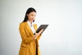 Portrait photo of young beautiful Asian woman feeling happy and holding smart phone, tablet and laptop with black empty screen on Royalty Free Stock Photo