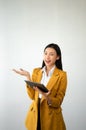 Portrait photo of young beautiful Asian woman feeling happy and holding smart phone, tablet and laptop with black empty screen on Royalty Free Stock Photo