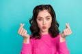 Portrait photo of young pretty funny woman grimace showing heart symbol fingers look youn pouted lips isolated on cyan Royalty Free Stock Photo