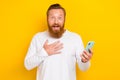 Portrait photo of young smiling shock crazy redhair man touch chest surprised million subscribers isolated on yellow Royalty Free Stock Photo