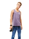 Portrait of the photographer as a young man. Studio portrait of a young man holding a camera next to his hip isolated on Royalty Free Stock Photo