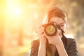 Portrait of a photographer covering her face with camera. Royalty Free Stock Photo