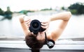 Portrait of a photographer covering her face with the camera.. Royalty Free Stock Photo