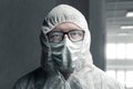 Portrait of physician with protective suit and steamed up glasses which reflecting an empty corridor of hospital Royalty Free Stock Photo