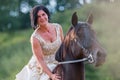 Portrait of a woman with bridal dress and Andalusian horse Royalty Free Stock Photo