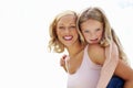 Portrait, piggy back and mother with girl, love or smile with happiness, bonding together or outdoor. Face, family or