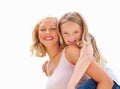 Portrait, piggy back and mother with girl, smile or fun with happiness, bonding together or outdoor. Face, family or