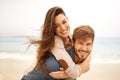Portrait, piggyback and happy couple hug at beach for travel, romance and freedom together. Face, smile and loving woman Royalty Free Stock Photo