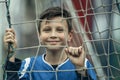 Portrait of player boy near the gate on the football field. Royalty Free Stock Photo