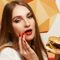 Playful girl posing with burger