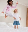 Portrait of playful siblings jumping