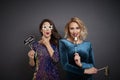 Playful women with photo booth partying Royalty Free Stock Photo