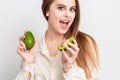 Portrait of pleasantly surprised woman with a two avocado