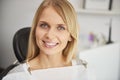 Portrait of pleased and smiling woman in dentist`s clinic