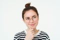 Portrait of pleased and thoughtful face, smiling satisifed, analizing smth, thinking, standing over white background Royalty Free Stock Photo