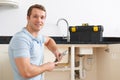 Portrait Of Plumber Fixing Sink