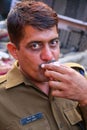 Portrait of policeman drinking chai at Johari Bazaar street in J